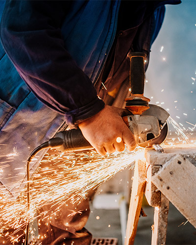 A person using grinder on site